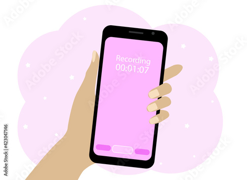 Hand with a mobile phone. The phone is recording a voice message