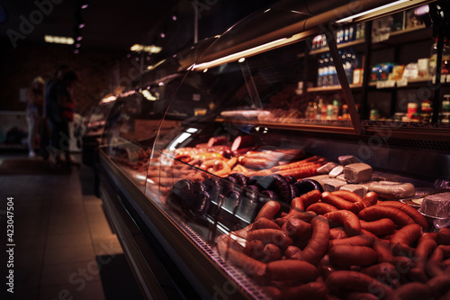 Sideview of a stylish butcher shop and its fridged counter with meat photo