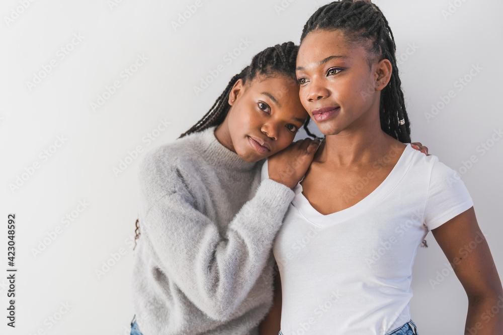mother and her teenage daughter on white