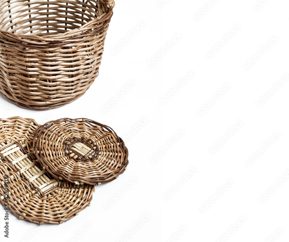 Fototapeta premium Wicker basket and bottoms for baskets isolated on white background