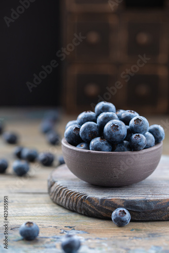 Fresh blueberries in a bowl on a wooden table photo
