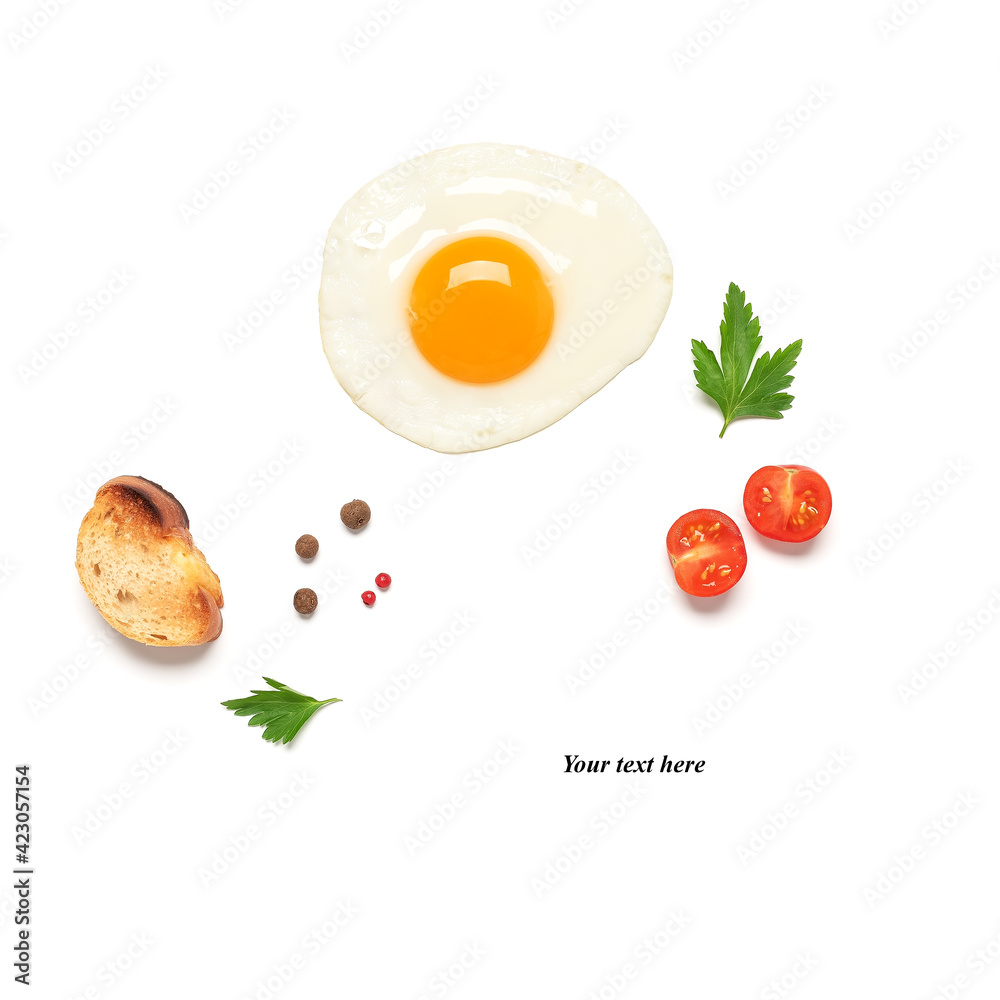 Fried egg isolated on a white background with tomato, spices and toast. Creative layout. Top view, flat lay. Breakfast concept. Fried egg isolated on a white background with tomato, spices and toast. Creative layout. Top view, flat lay. Breakfast concept.