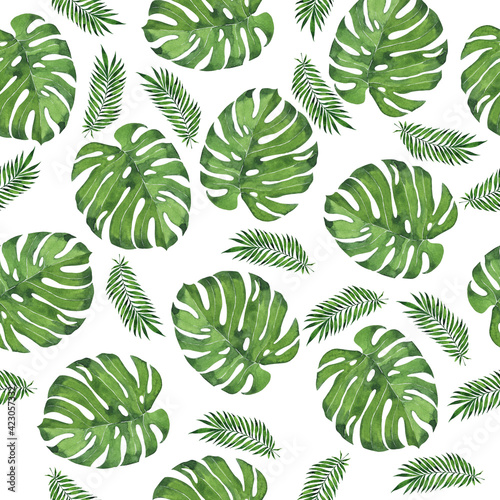 Seamless pattern with green tropic monstera and palm leaves. Hand drawn watercolor illustration.
