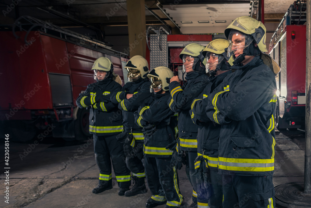 Group of firefighters standing confident with arms crossed. Firemen ready for emergency service. Group of firefighters standing confident with arms crossed. Firemen ready for emergency service.