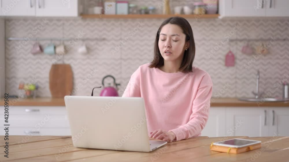 Stressed exhausted young chinese lady working from home take off glasses feel eye strain fatigued from laptop computer. Tired mixed race asian woman suffer from headache pain, remote work concept Stressed exhausted young chinese lady working from home take off glasses feel eye strain fatigued from laptop computer. Tired mixed race asian woman suffer from headache pain, remote work concept