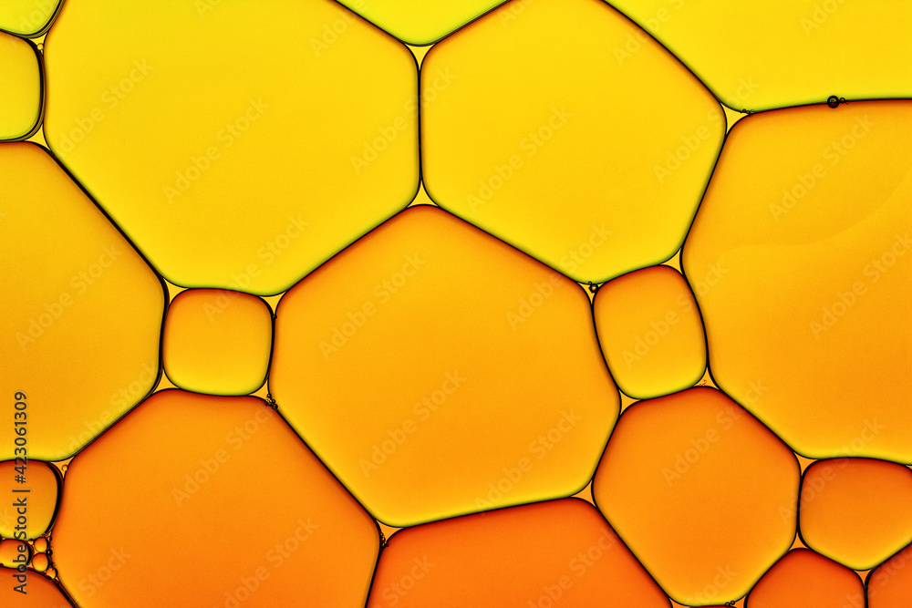Bright Hot Background Closeup of Oil Drops in Water. Abstract Art Macro Photo of Liquid Surface with Gradient Yellow and Orange Bubbles. - obrazy, fototapety, plakaty 