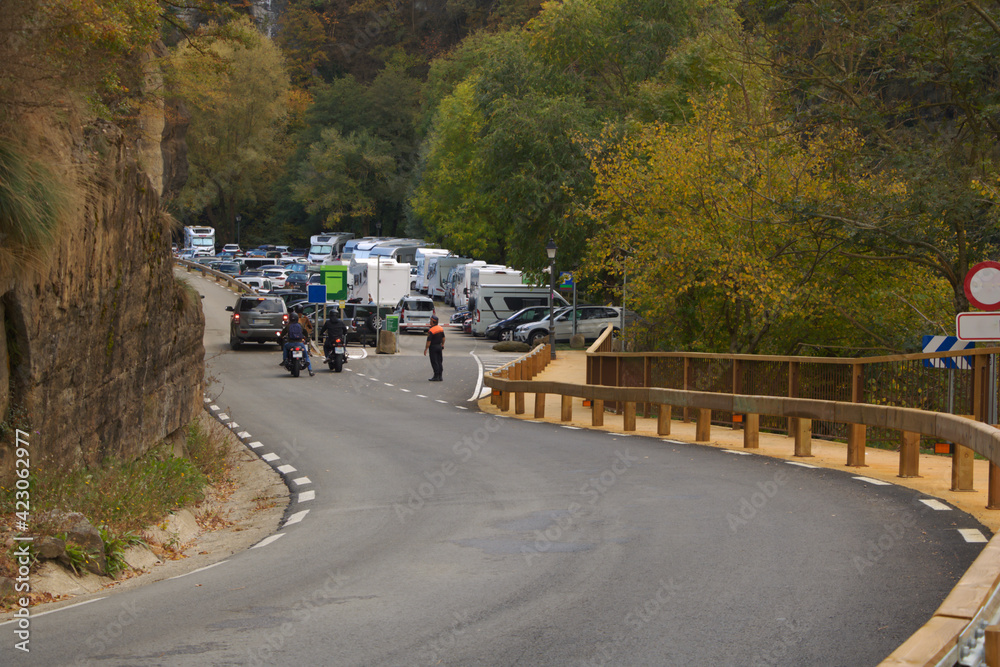 Photo of a policeman organizing the traffic of a parking lot in the middle of nature. Photo of a policeman organizing the traffic of a parking lot in the middle of nature.