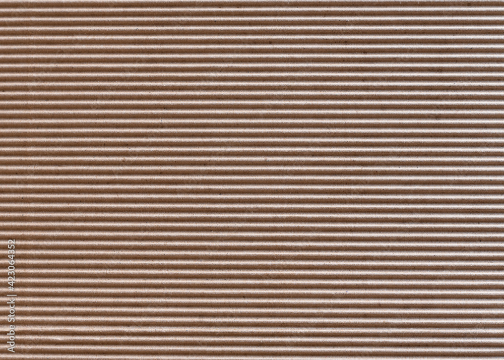 The texture of horizontally corrugated brown cardboard, background. The texture of horizontally corrugated brown cardboard, background.