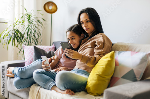 Single parenthood. Mother and daughter spending time together at home.
