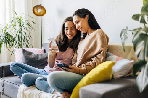 Single parenthood. Mother and daughter spending time together at home. photo