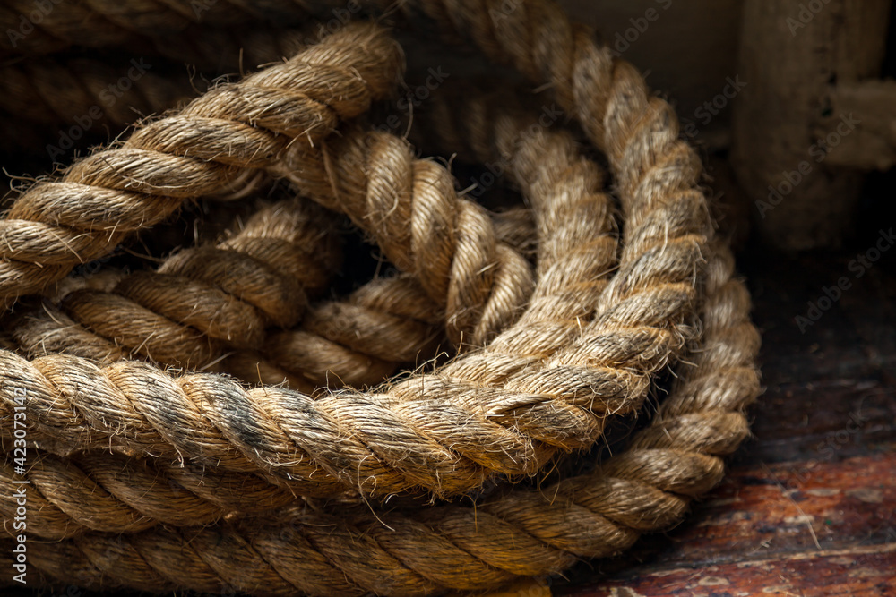 Rope on the deck of the ferry on background of the old wooden floor