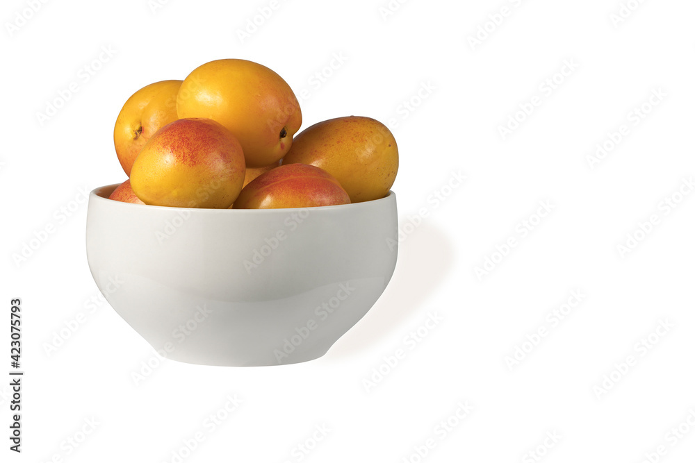 juicy sweet apricots in a ceramic cup isolated on white background juicy sweet apricots in a ceramic cup isolated on white background