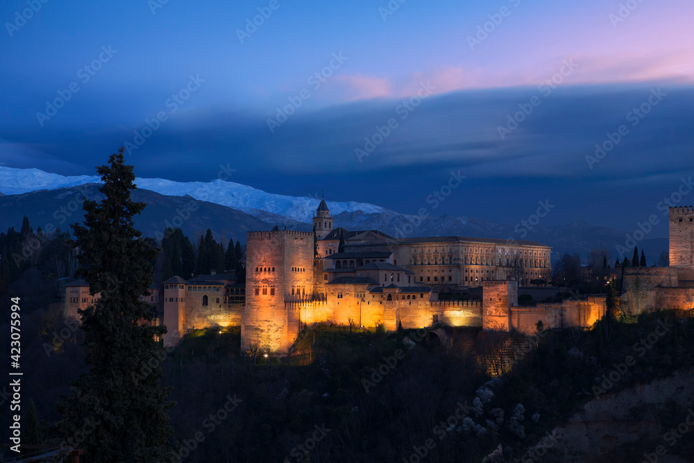 Classic view of the Alhambra from Mirador de San Nicolás, El Albaicín, Granada, Spain, at late evening
