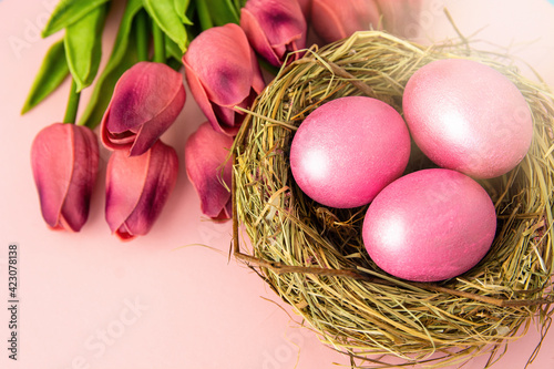 easter background with delicate color pink paint eggs on beige background