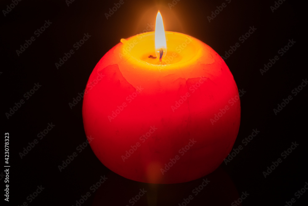 Big spherical candle shines in the dark. Big spherical candle shines in the dark.