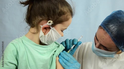 A doctor injects a vaccine to a child during a coronavirus outbreak. Vaccination of children against Covid-19 during the coronavirus outbreak. Vaccination of children against coronavirus. 