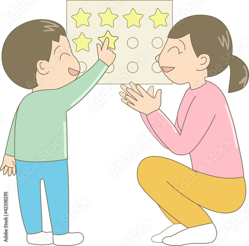 ポスターにシールを貼る男の子と褒める母親