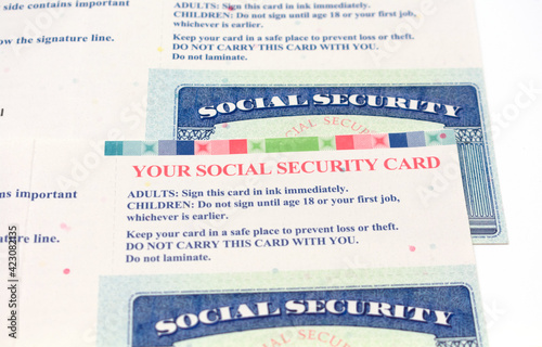 Selective focus. Two social security cards with an instructions how to sign and store government documents photo