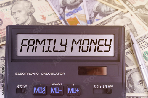 On the table are dollars and a calculator on the electronic board which says FAMILY MONEY