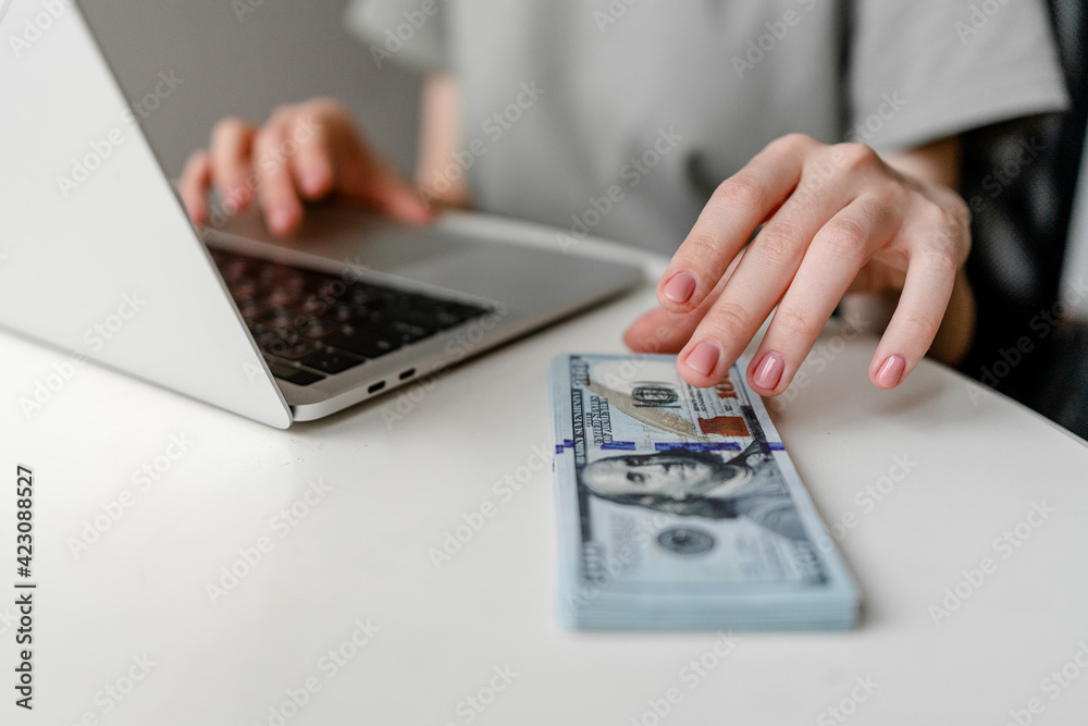 Freelancer Woman Using Laptop Computer making money closeup Freelancer Woman Using Laptop Computer making money closeup