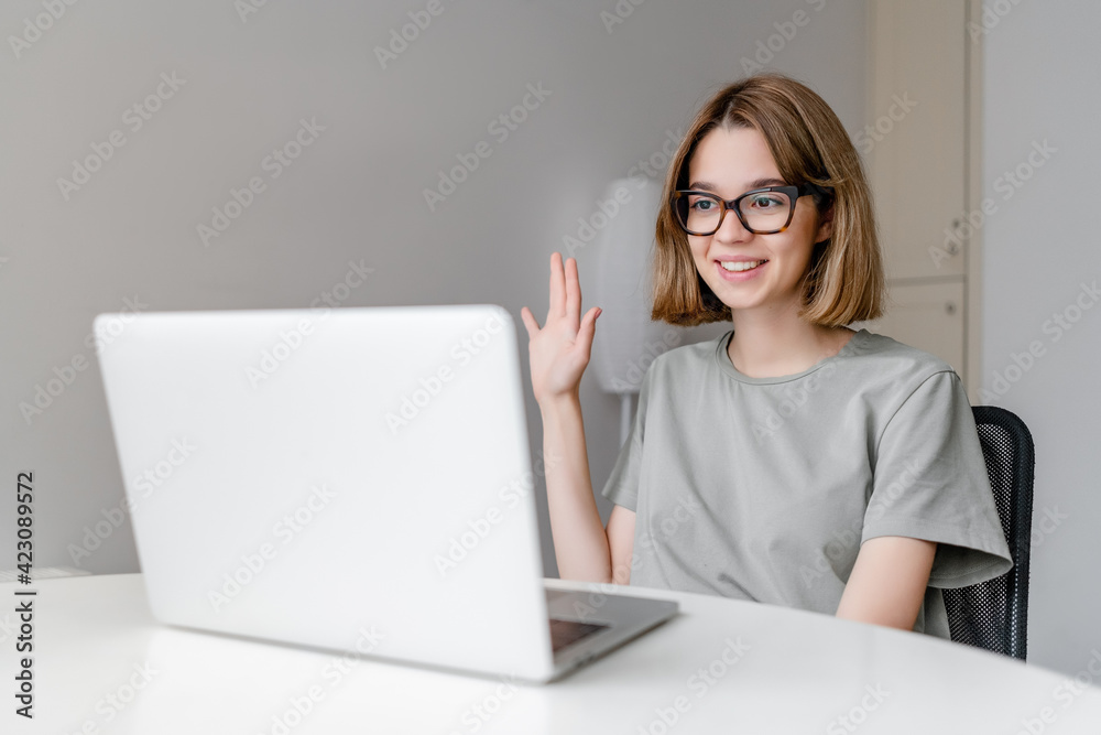 young relaxed caucasian woman smiling sitting with laptop in the apartment
