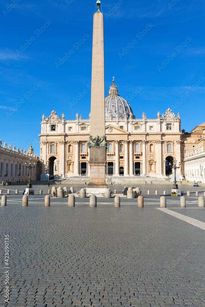 Facade of Saint Peter's Basilica Egyptian and obelisk at St.Peter's square. Few tourists wearing face masks due to the Covid-19 coronovirus pandemic, Vatican, Rome, Italy