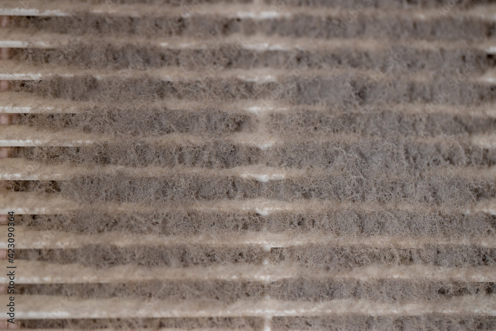 Very dirty and dusty white plastic ventilation grill. Ventilation shaft in the apartment. dirty air filter. House cleaning concept.
