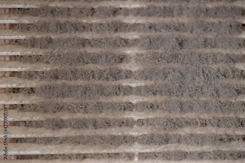 Very dirty and dusty white plastic ventilation grill. Ventilation shaft in the apartment. dirty air filter. House cleaning concept.
