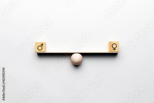 Fotografie Gender equality concept on abstract scales with masculine and feminine icons
