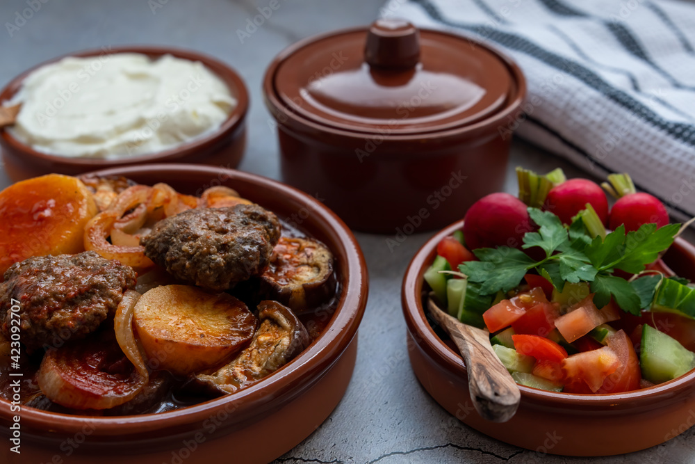 Kwaj a dish, prepared from a mix of vegetables ,tomato, zucchini, eggplant, potato, onion and green pepper and meat all together cooked in the oven. Kwaj a dish, prepared from a mix of vegetables ,tomato, zucchini, eggplant, potato, onion and green pepper and meat all together cooked in the oven.