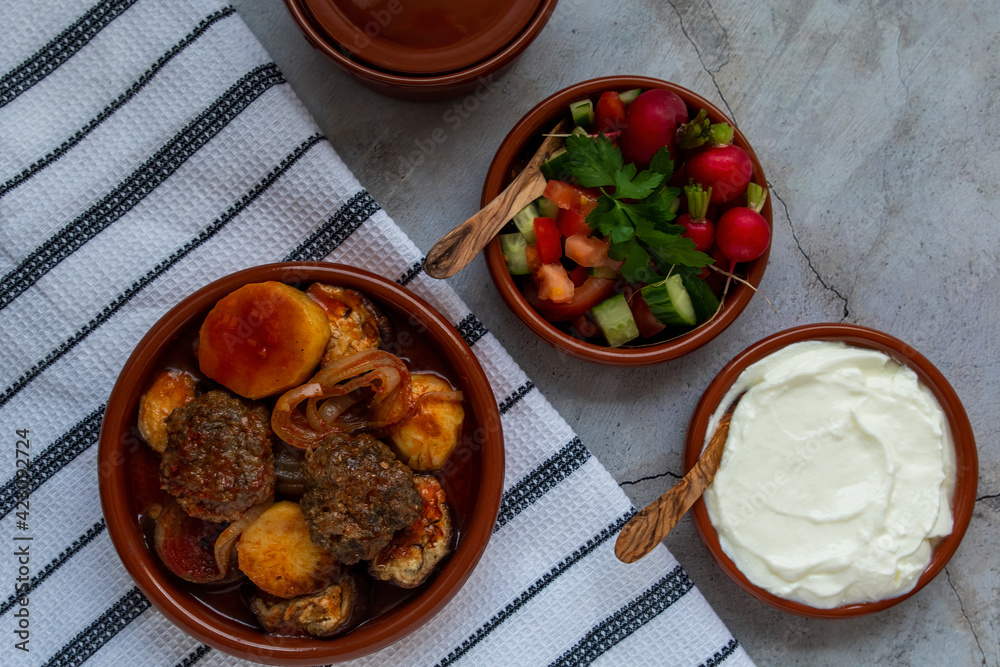 Kwaj a dish, prepared from a mix of vegetables ,tomato, zucchini, eggplant, potato, onion and green pepper and meat all together cooked in the oven.