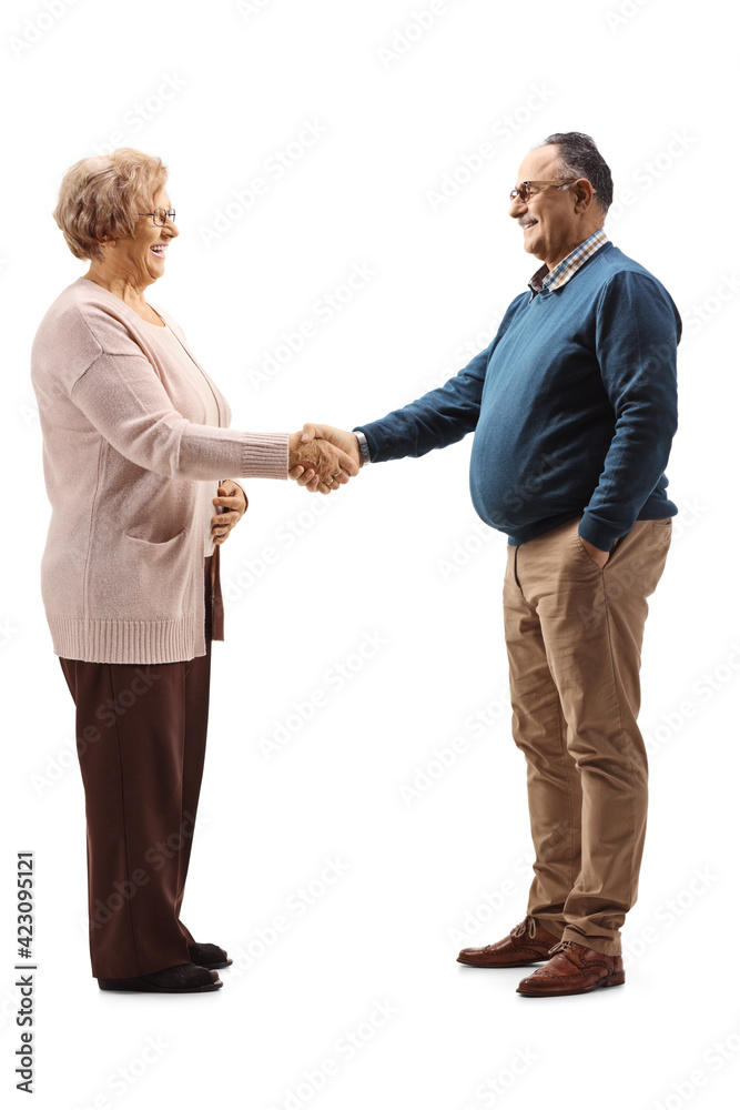 Full length profile shot of an elderly woman shaking hand with a mature man Full length profile shot of an elderly woman shaking hand with a mature man