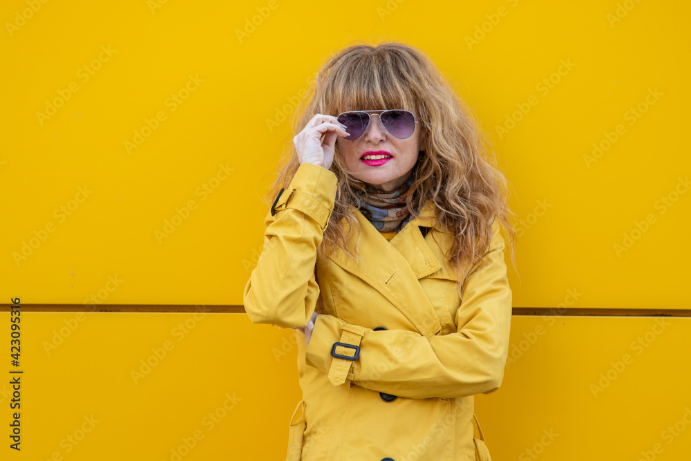 portrait of adult woman on the yellow wall portrait of adult woman on the yellow wall