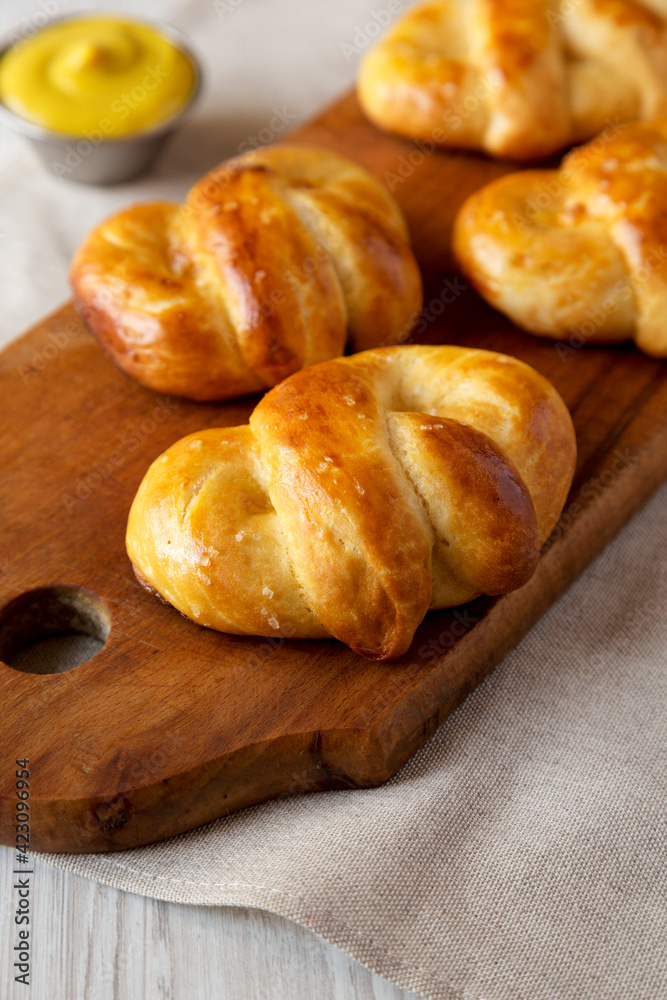 Homemade Basic Soft Pretzels with Mustard, low angle view. Close-up.