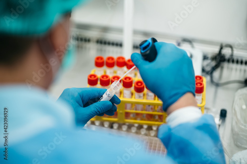 The PCR tester takes a sample analysis from a test tube photo