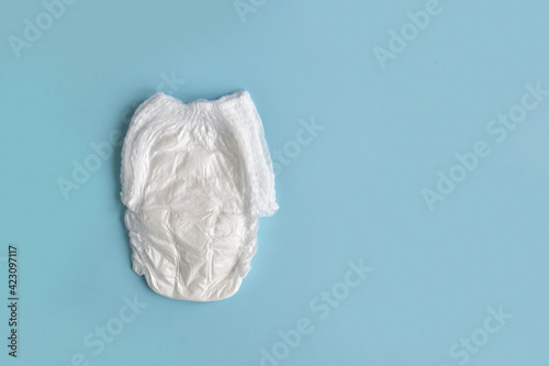 Baby diaper on a blue background. copy the space. Flat lay