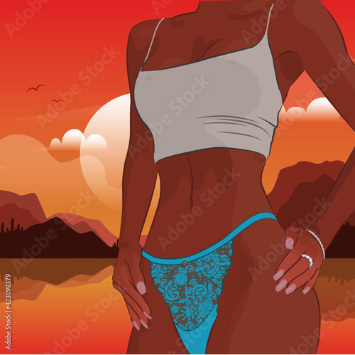 The beautiful figure of a slender girl stands against the background of the sunset and the sea.