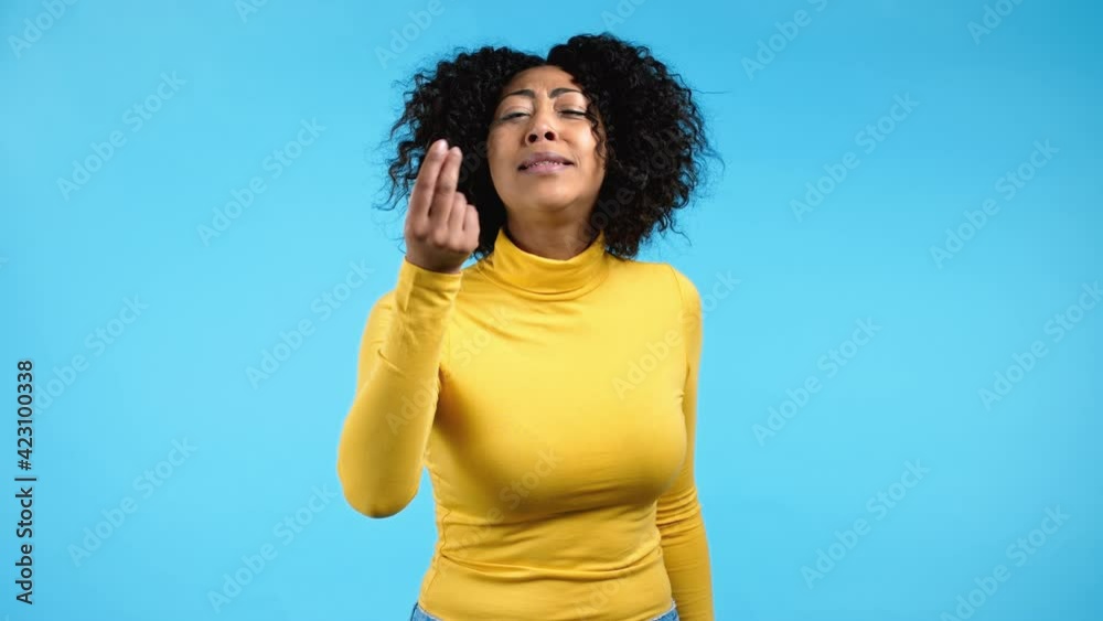 African woman making delicious, perfect gesture. Girl admires taste of italian food on blue studio background. Bellissimo concept. African woman making delicious, perfect gesture. Girl admires taste of italian food on blue studio background. Bellissimo concept.