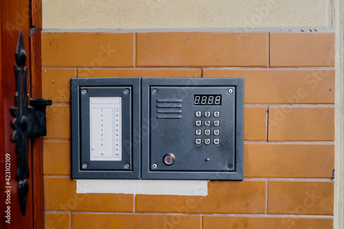 intercom on wall, entrance to tenement house