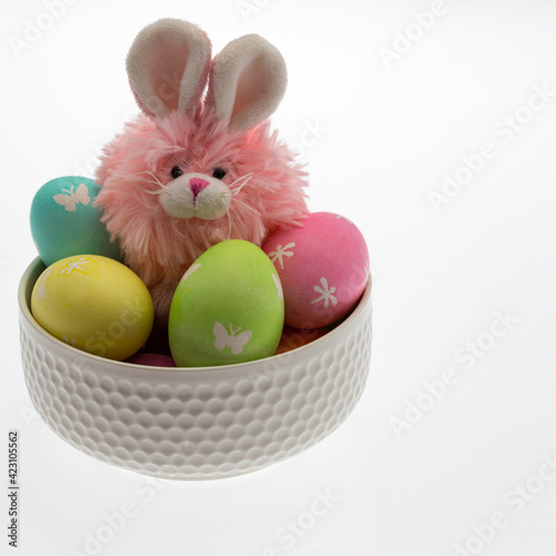 Easter themed still life with pink plush bunny and hand dyed easter eggs.
