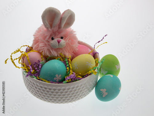 Easter themed still life with pink plush bunny and hand dyed easter eggs.
