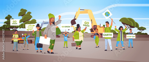 activists holding posters go green save planet strike concept mix race protesters campaigning to protect earth demonstrating against global warming portrait quarry landscape background horizontal