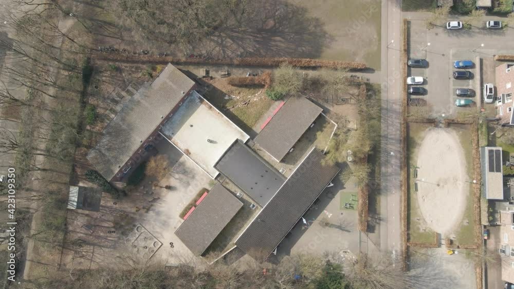 Top down aerial of children playing on grade school playground - drone setting down Top down aerial of children playing on grade school playground - drone setting down