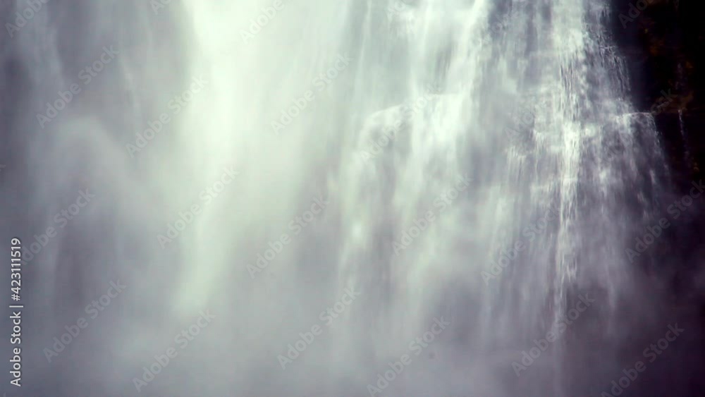 Sheets of water and mist splashing down the mountain in the form of a powerful waterfall Sheets of water and mist splashing down the mountain in the form of a powerful waterfall