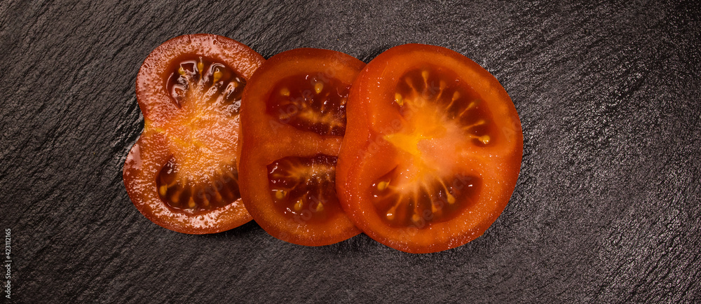Freshly sliced tomato slices - top down view - food photography Freshly sliced tomato slices - top down view - food photography