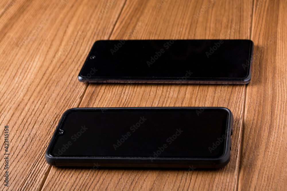 Mobile phone with blank screen on wooden table background. Smartphone on wooden old planks vintage texture background. top view, copy space Mobile phone with blank screen on wooden table background. Smartphone on wooden old planks vintage texture background. top view, copy space