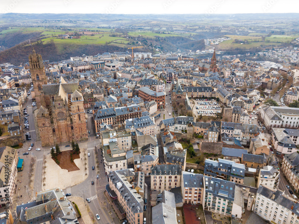 Aerial view of French city of Rodez with tower of Cathedral and spire of church of Saint Amans in autumn day