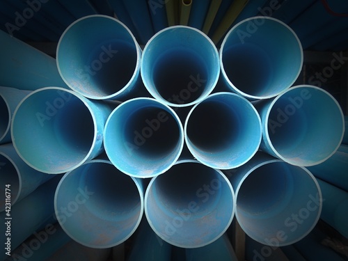 Close up multi size of blue pvc pipe on the metal rack 