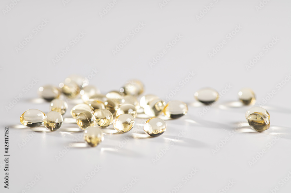 Vitamin D in the form of yellow capsules on a white background Vitamin D in the form of yellow capsules on a white background