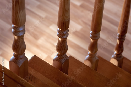 Obraz na plátně Element of a wooden interior staircase. Wooden baluster close-up.